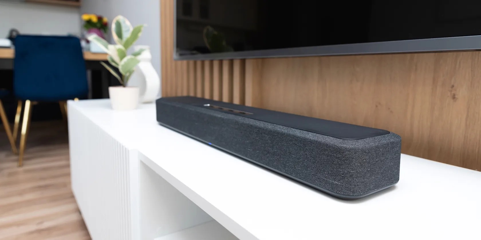 Soundbar mounted below a TV in a living room